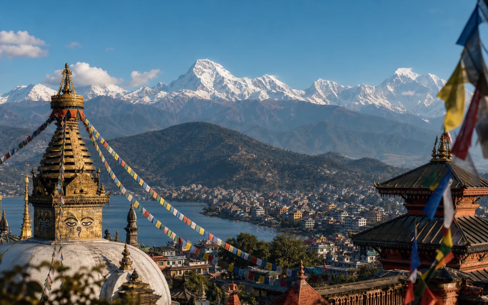 Nepal temple rooftops and prayer flags overlooking a Himalayan valley